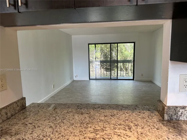 a view of a hallway with a window