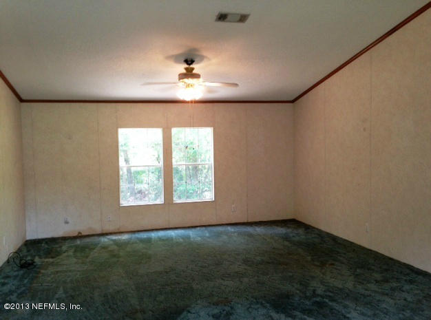 96135 Durden Road Yulee, FL 32097 - Photo 2 of 10 an empty room with a empty space and windows