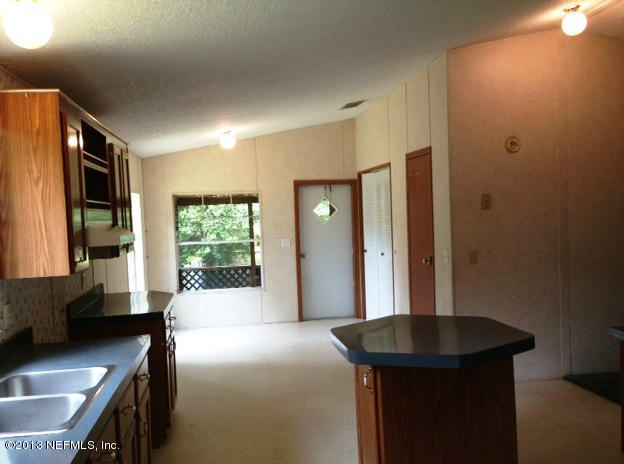 96135 Durden Road Yulee, FL 32097 - Photo 4 of 10 a bedroom with a bed window and a sink