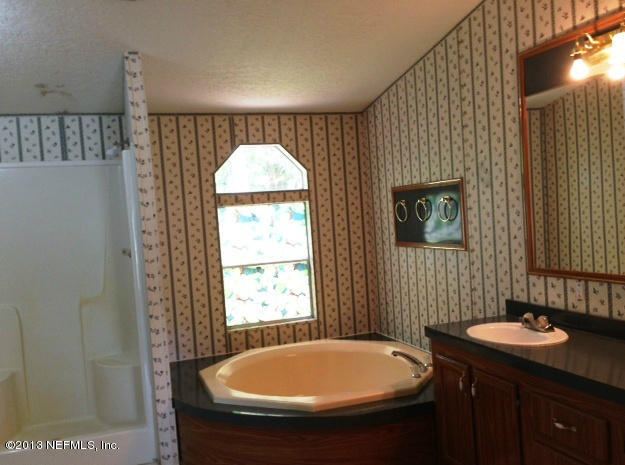 96135 Durden Road Yulee, FL 32097 - Photo 6 of 10 a bathroom with a sink and a mirror