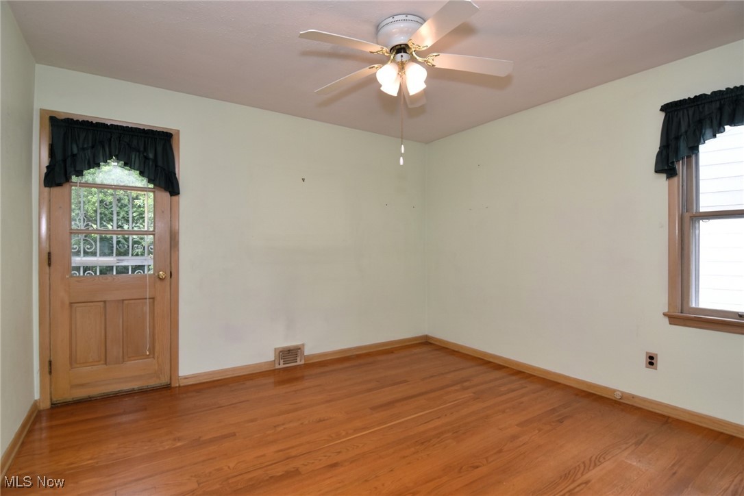 9421 David Road Cleveland, OH 44125 - Photo 21 of 36 Empty room with light wood-style floors and ceiling fan