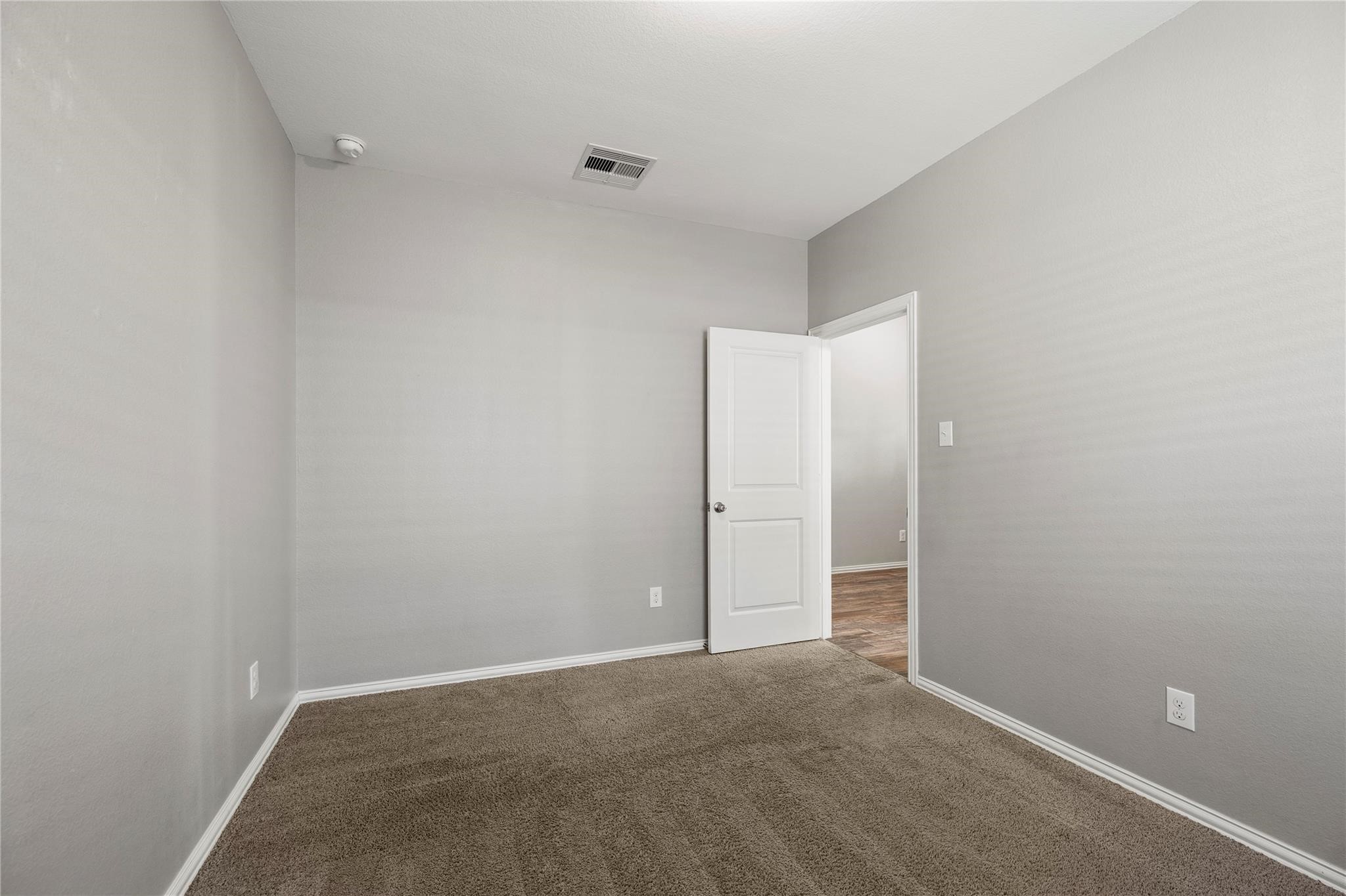 29507 Whitebrush Trace Drive Spring, TX 77386 - Photo 7 of 32 Secondary bedroom with carpet flooring and neutral wall color.
