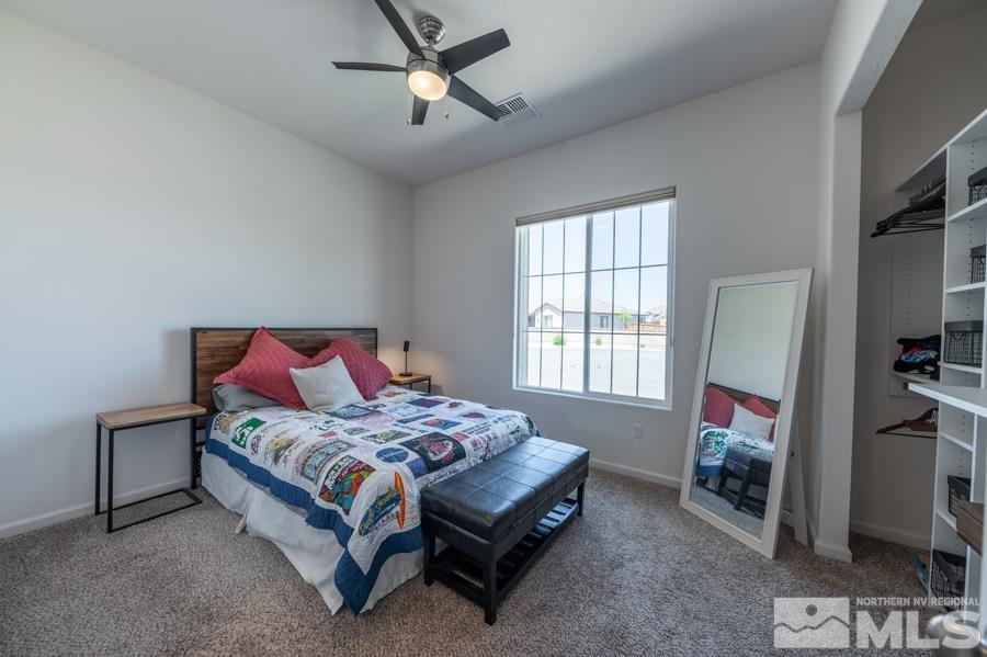 30 Phaethon Court Reno, NV 89521 - Photo 19 of 39 a bedroom with a bed furniture and a flat tv screen