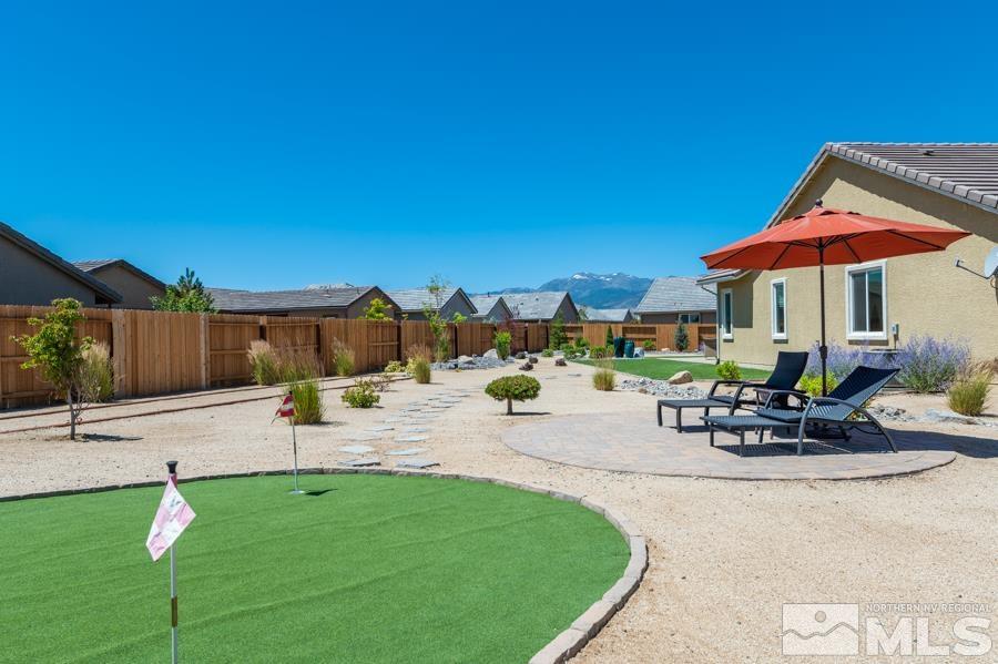 30 Phaethon Court Reno, NV 89521 - Photo 30 of 39 a view of a patio with a table and chairs under an umbrella
