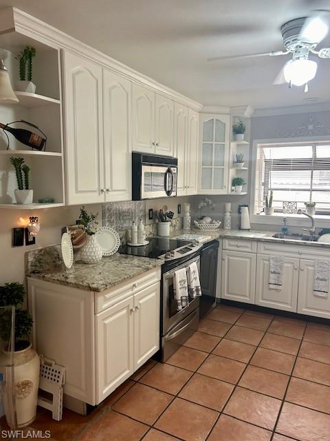 4201 19th Place Southwest Naples, FL 34116 - Photo 7 of 12 a kitchen with stainless steel appliances granite countertop a sink and cabinets