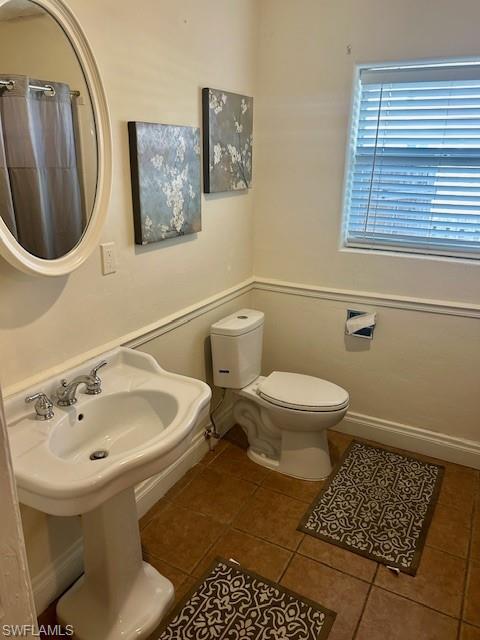 4201 19th Place Southwest Naples, FL 34116 - Photo 9 of 12 a bathroom with a toilet and a sink