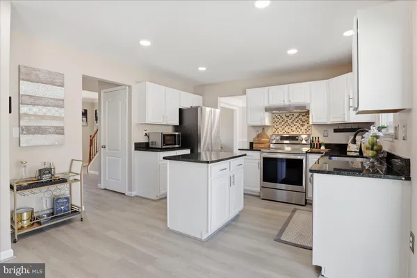 a living room with furniture a fireplace and window
