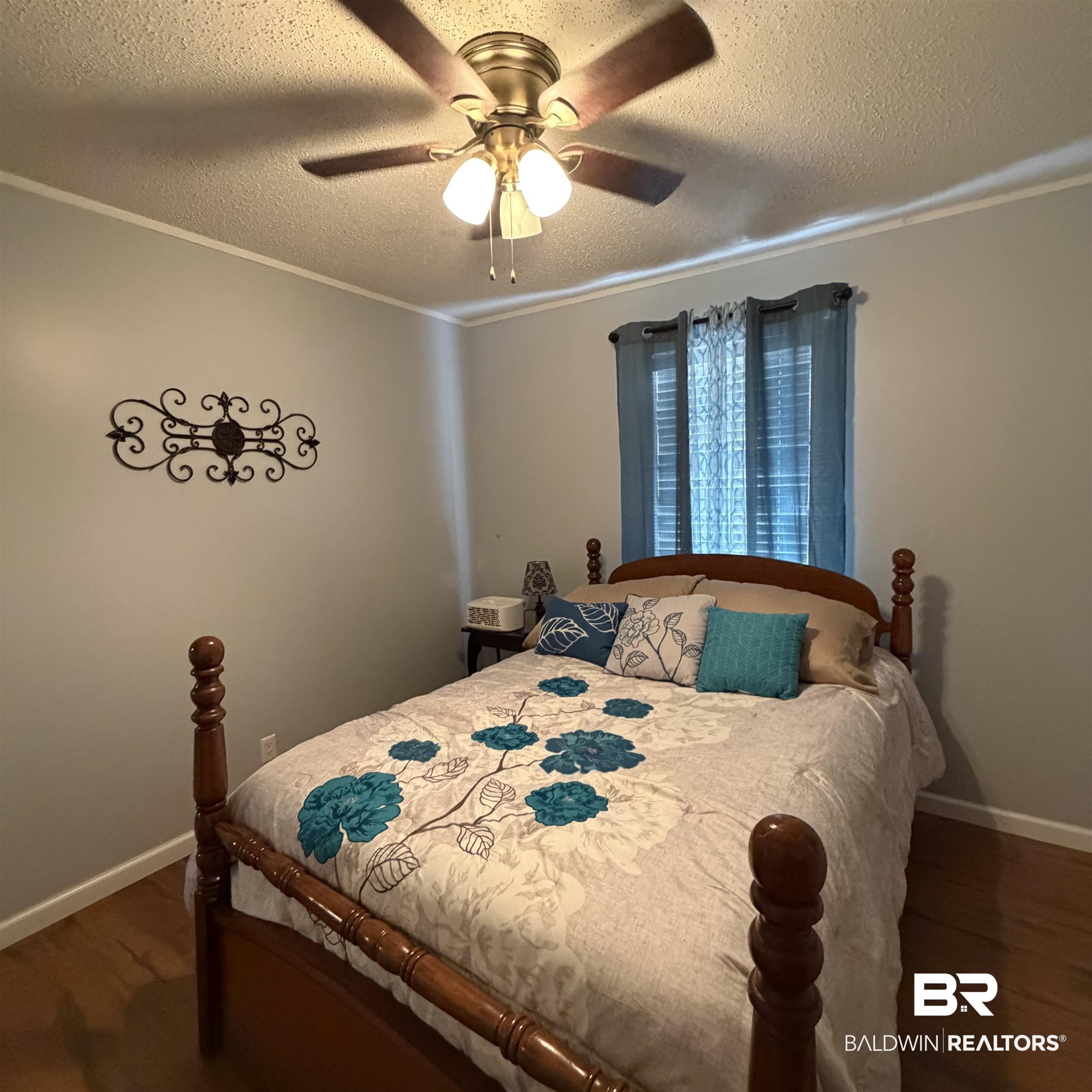 447 Sugar Hill Road Monroeville, AL 36460 - Photo 16 of 27 Bedroom with dark wood-type flooring, a textured ceiling, ceiling fan, and crown molding