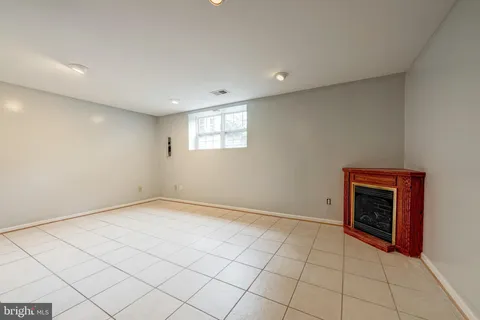 a view of an empty room with a fireplace