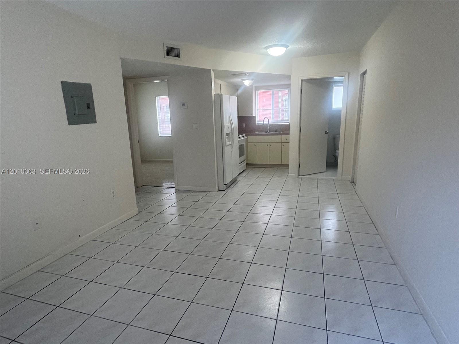 1419 Southwest 22nd Avenue, Unit 4 Miami, FL 33145 - Photo 7 of 11 a view of a livingroom with an empty space and a window