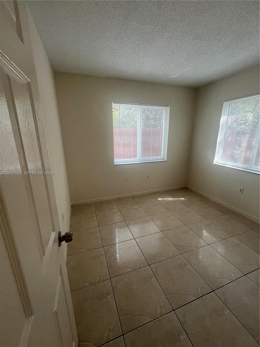 1419 Southwest 22nd Avenue, Unit 4 Miami, FL 33145 - Photo 8 of 11 a view of an empty room and a window