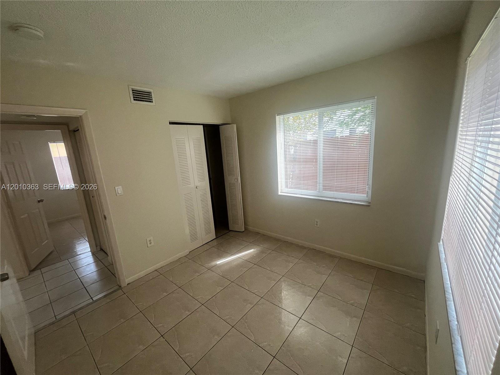 1419 Southwest 22nd Avenue, Unit 4 Miami, FL 33145 - Photo 9 of 11 an empty room with windows