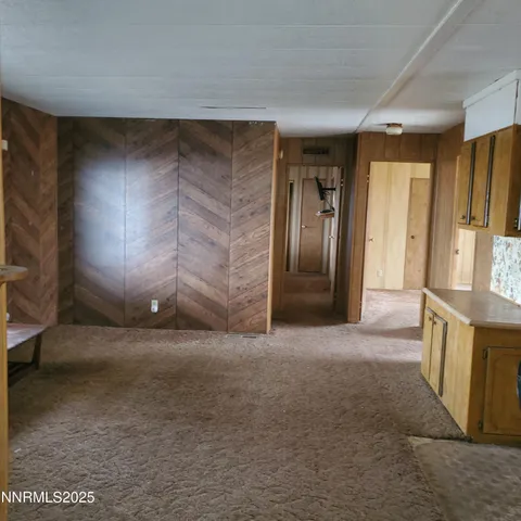 a view of empty room with a fireplace