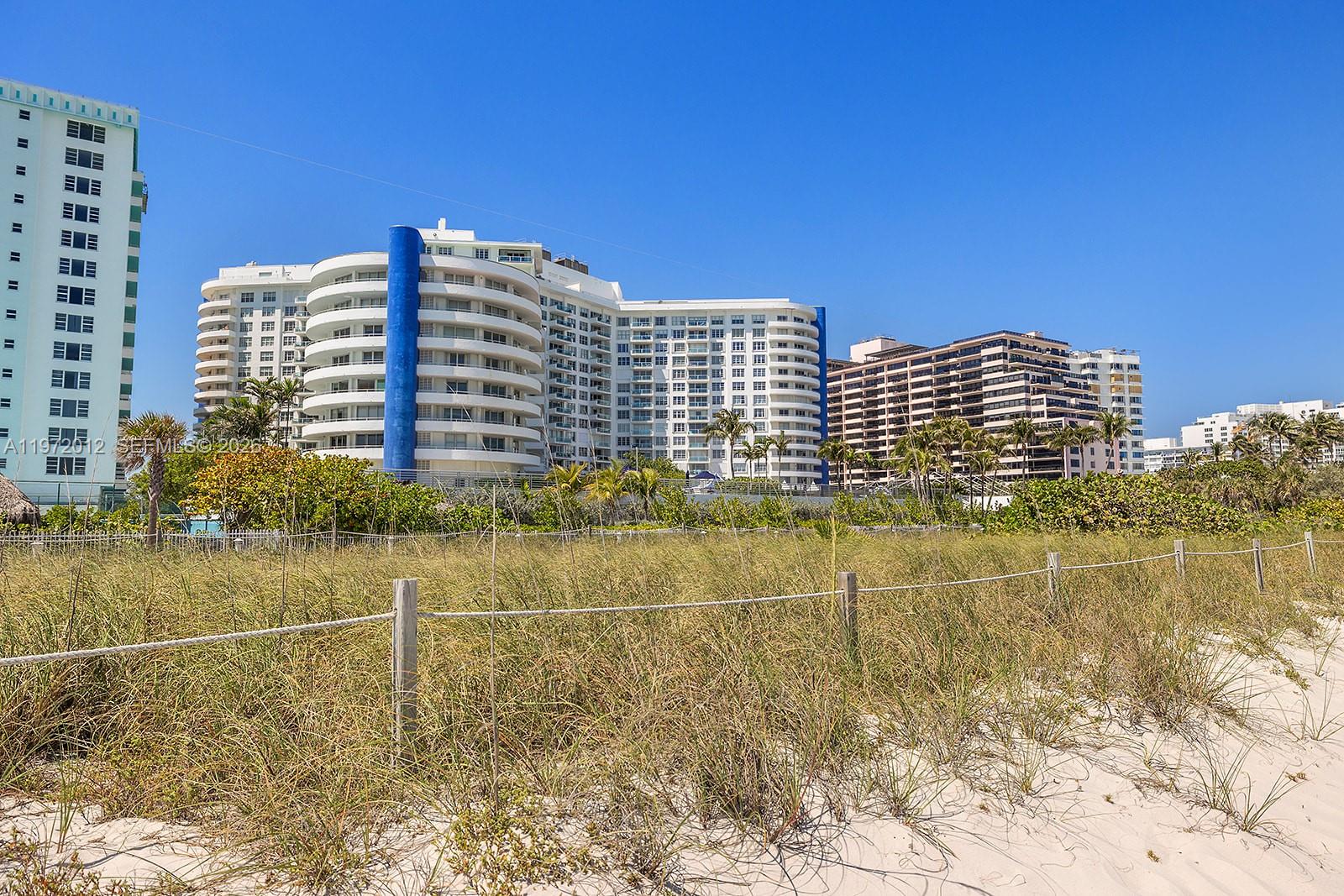 5161 Collins Avenue, Unit 910 Miami Beach, FL 33140 - Photo 15 of 18 a view of a building with a yard