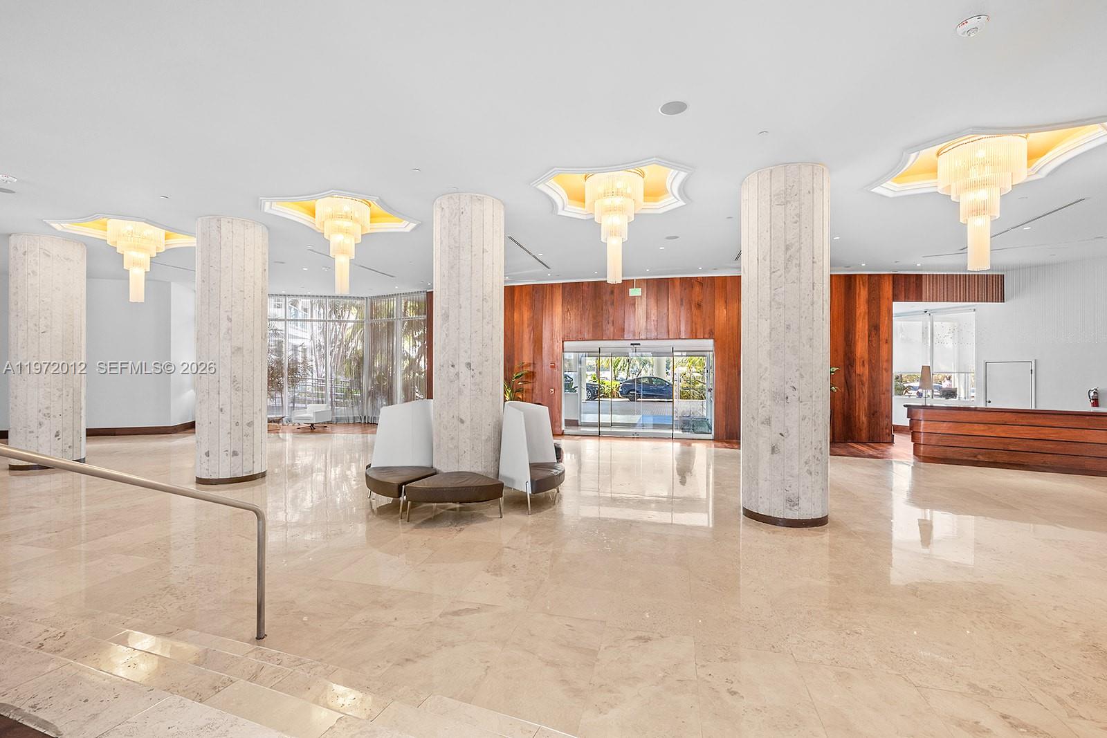 5161 Collins Avenue, Unit 910 Miami Beach, FL 33140 - Photo 3 of 18 a living room with furniture and a large window