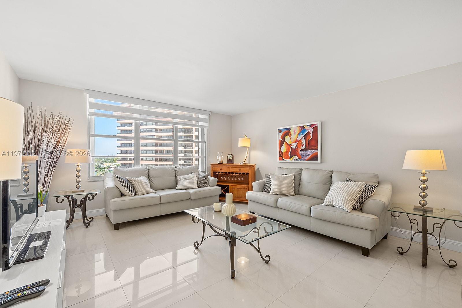 5161 Collins Avenue, Unit 910 Miami Beach, FL 33140 - Photo 5 of 18 a living room with furniture and a large window