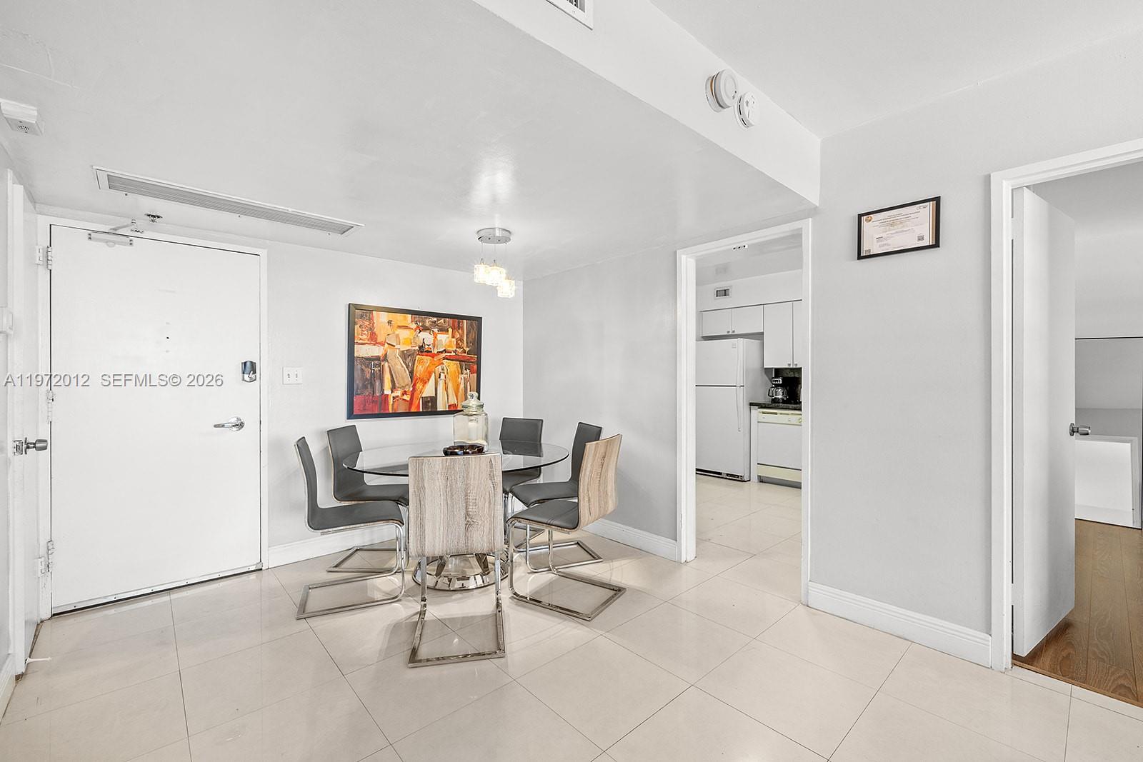 5161 Collins Avenue, Unit 910 Miami Beach, FL 33140 - Photo 7 of 18 a view of kitchen with furniture and wooden floor