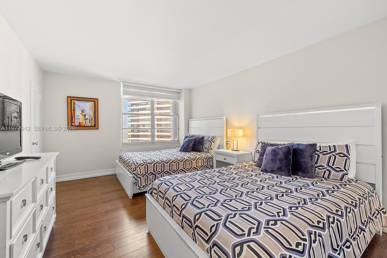 5161 Collins Avenue, Unit 910 Miami Beach, FL 33140 - Photo 8 of 18 a bedroom with a large bed and a window