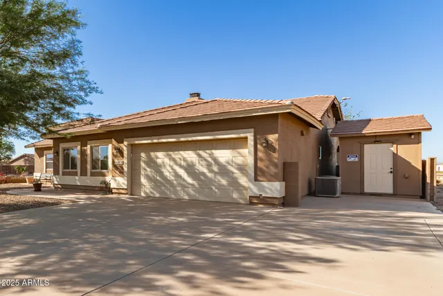a view of the house with backyard and trees