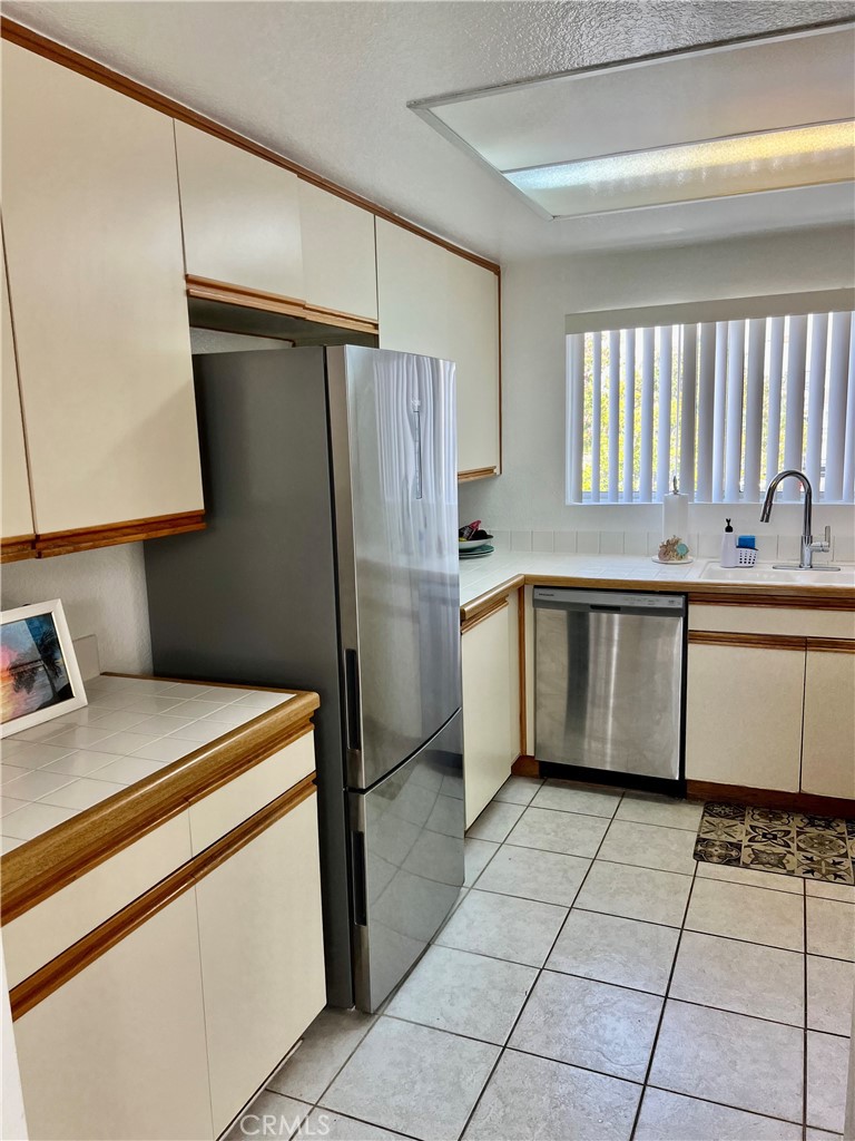 27857 Ruby, Unit 63 Mission Viejo, CA 92691 - Photo 13 of 23 a kitchen with a sink appliances and cabinets