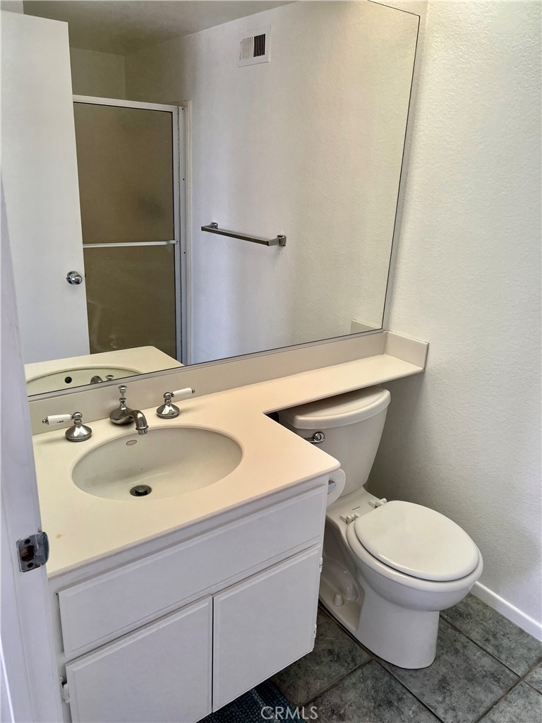 27857 Ruby, Unit 63 Mission Viejo, CA 92691 - Photo 22 of 23 a bathroom with a sink a toilet and shower