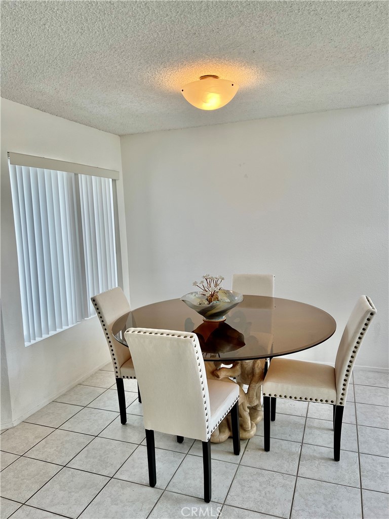 27857 Ruby, Unit 63 Mission Viejo, CA 92691 - Photo 5 of 23 a view of a dining room with furniture and a potted plant