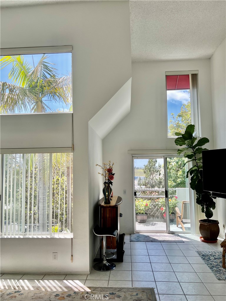 27857 Ruby, Unit 63 Mission Viejo, CA 92691 - Photo 7 of 23 a living room with furniture and a floor to ceiling window