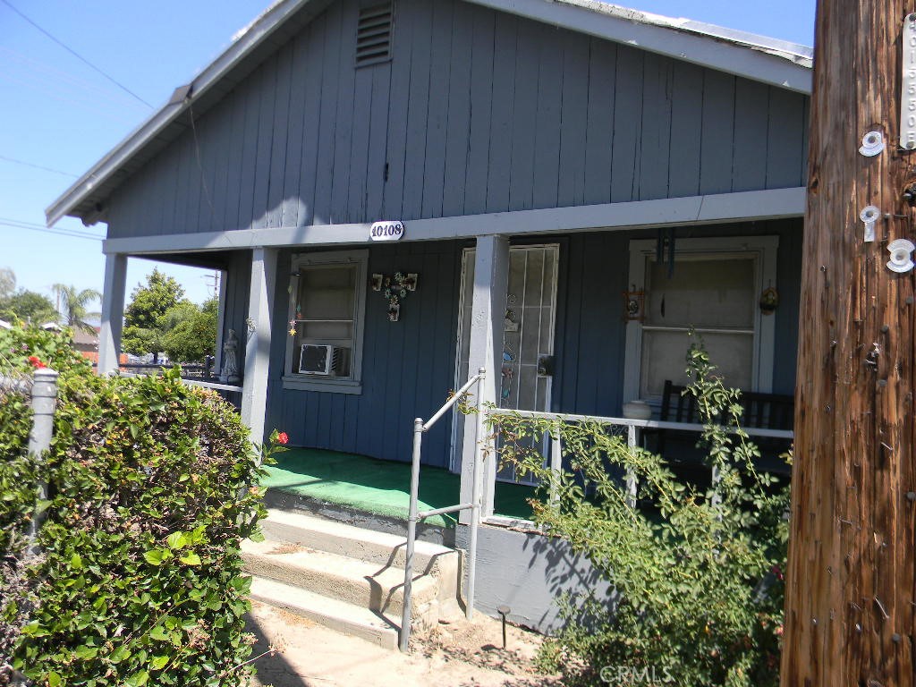 a couple of potted plants in front of door
