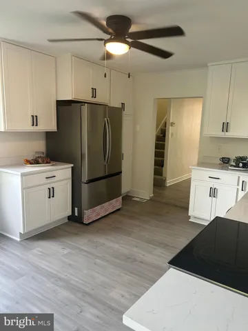 a kitchen with stainless steel appliances a refrigerator and a stove top oven