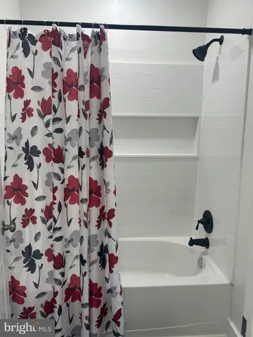 a bathroom with a bathtub and shower