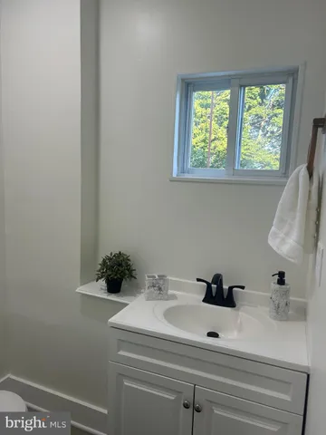 a bathroom with a sink and mirror