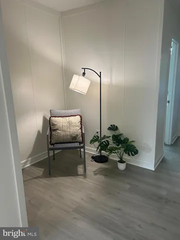 a hallway with a table and a couch