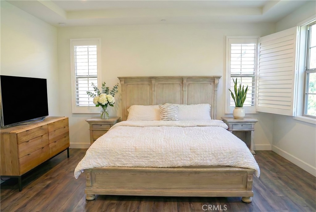 109 Sugar Cane Irvine, CA 92620 - Photo 11 of 26 a spacious bedroom with a bed and a flat screen tv