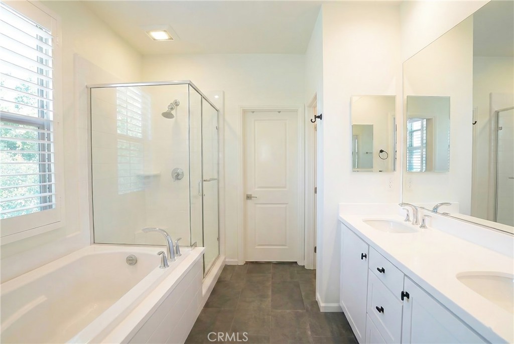 109 Sugar Cane Irvine, CA 92620 - Photo 12 of 26 a spacious bathroom with a tub shower sink and mirror
