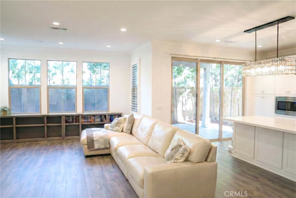 109 Sugar Cane Irvine, CA 92620 - Photo 5 of 26 a living room with furniture and large windows