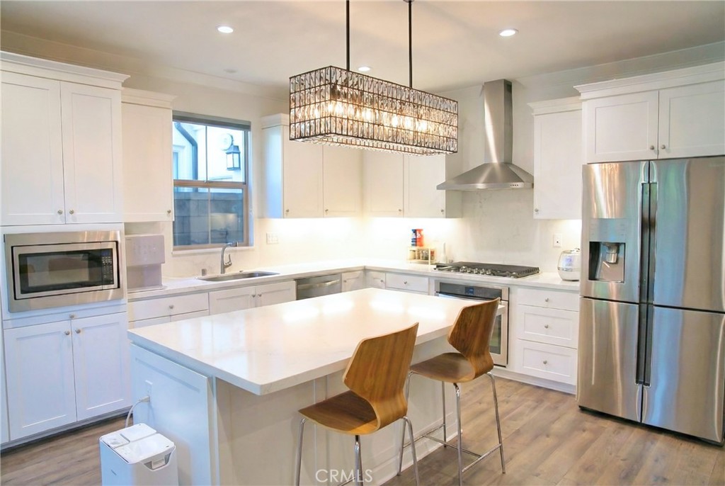 109 Sugar Cane Irvine, CA 92620 - Photo 6 of 26 a kitchen with stainless steel appliances granite countertop a stove refrigerator and cabinets