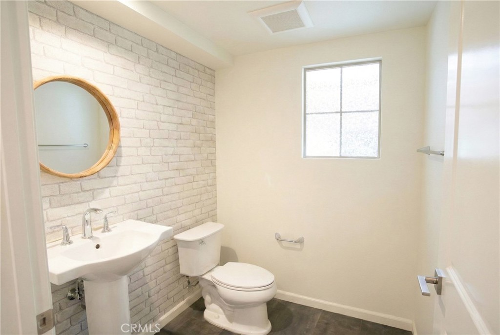 109 Sugar Cane Irvine, CA 92620 - Photo 9 of 26 a bathroom with a sink a toilet and a mirror