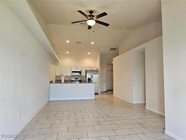 a view of a kitchen with a sink and a refrigerator