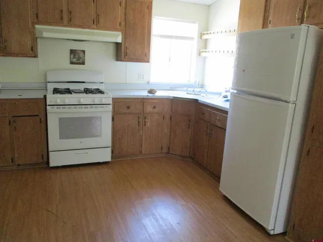 a kitchen with a refrigerator stove and sink