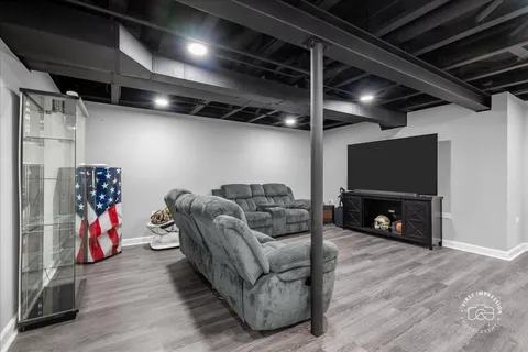 a living room with furniture a ceiling fan and a rug