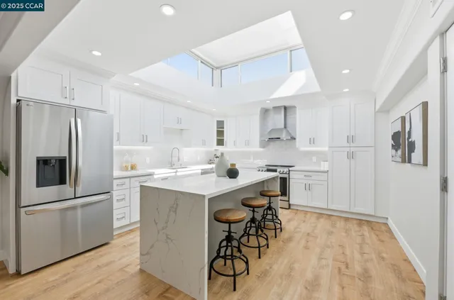 a kitchen with a sink a refrigerator and a stove top oven