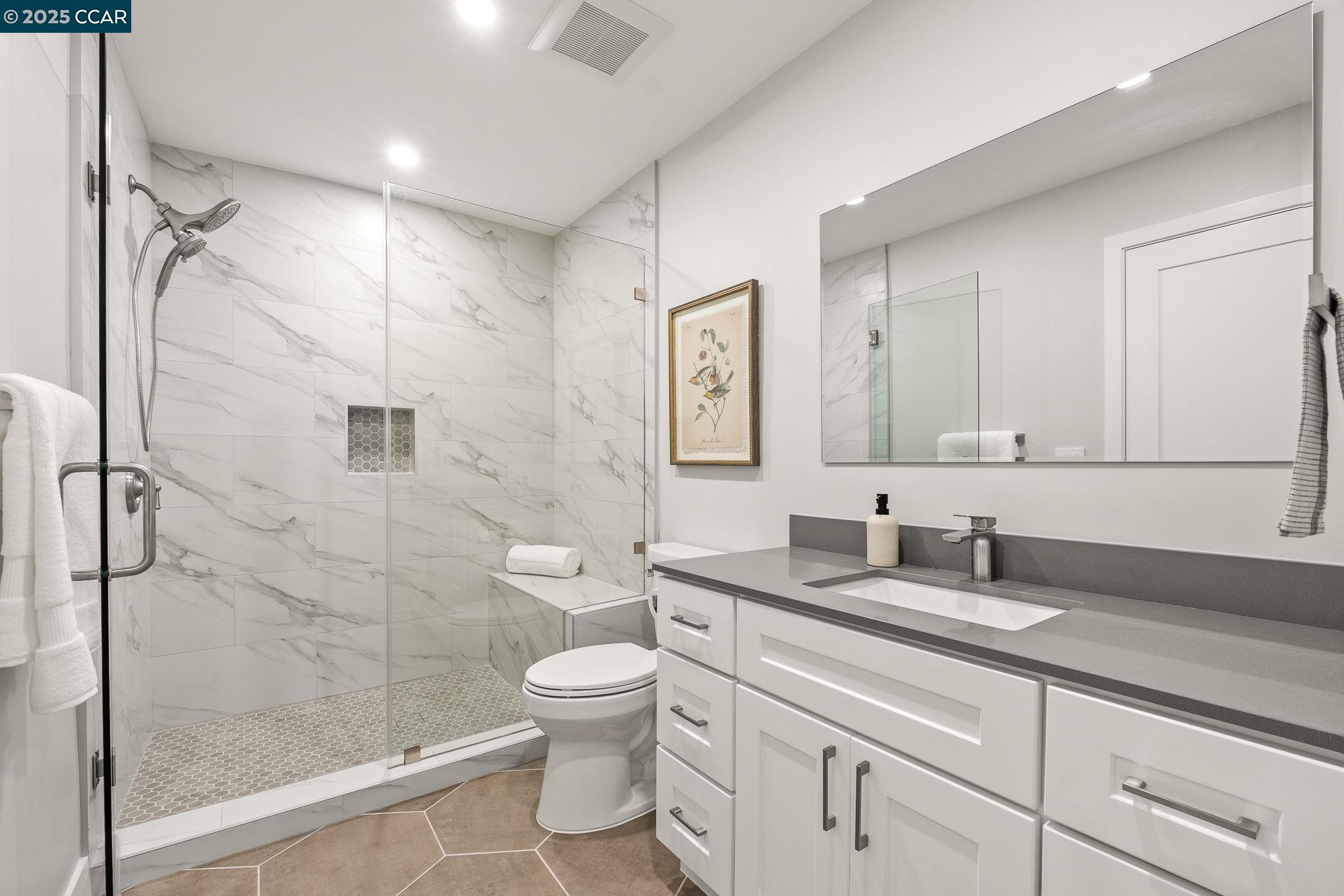 2132 Golden Rain Road, Unit 2 Walnut Creek, CA 94595 - Photo 11 of 38 a bathroom with a granite countertop sink toilet and shower