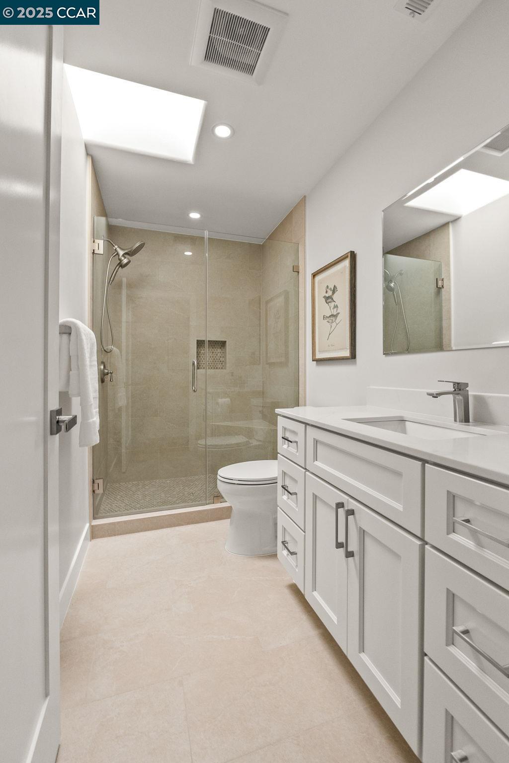 2132 Golden Rain Road, Unit 2 Walnut Creek, CA 94595 - Photo 14 of 38 a spacious bathroom with a shower sink vanity mirror and toilet