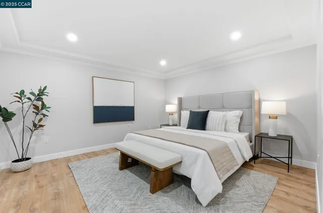 a spacious bedroom with a bed and a potted plant