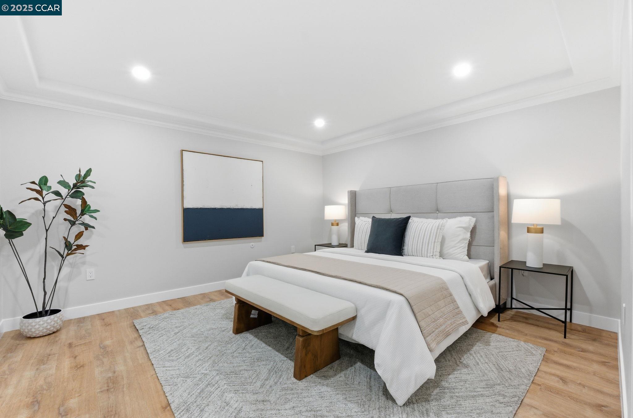 2132 Golden Rain Road, Unit 2 Walnut Creek, CA 94595 - Photo 15 of 38 a spacious bedroom with a bed and a potted plant