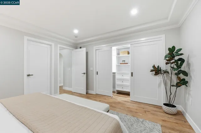 a bedroom with a bed and a potted plant