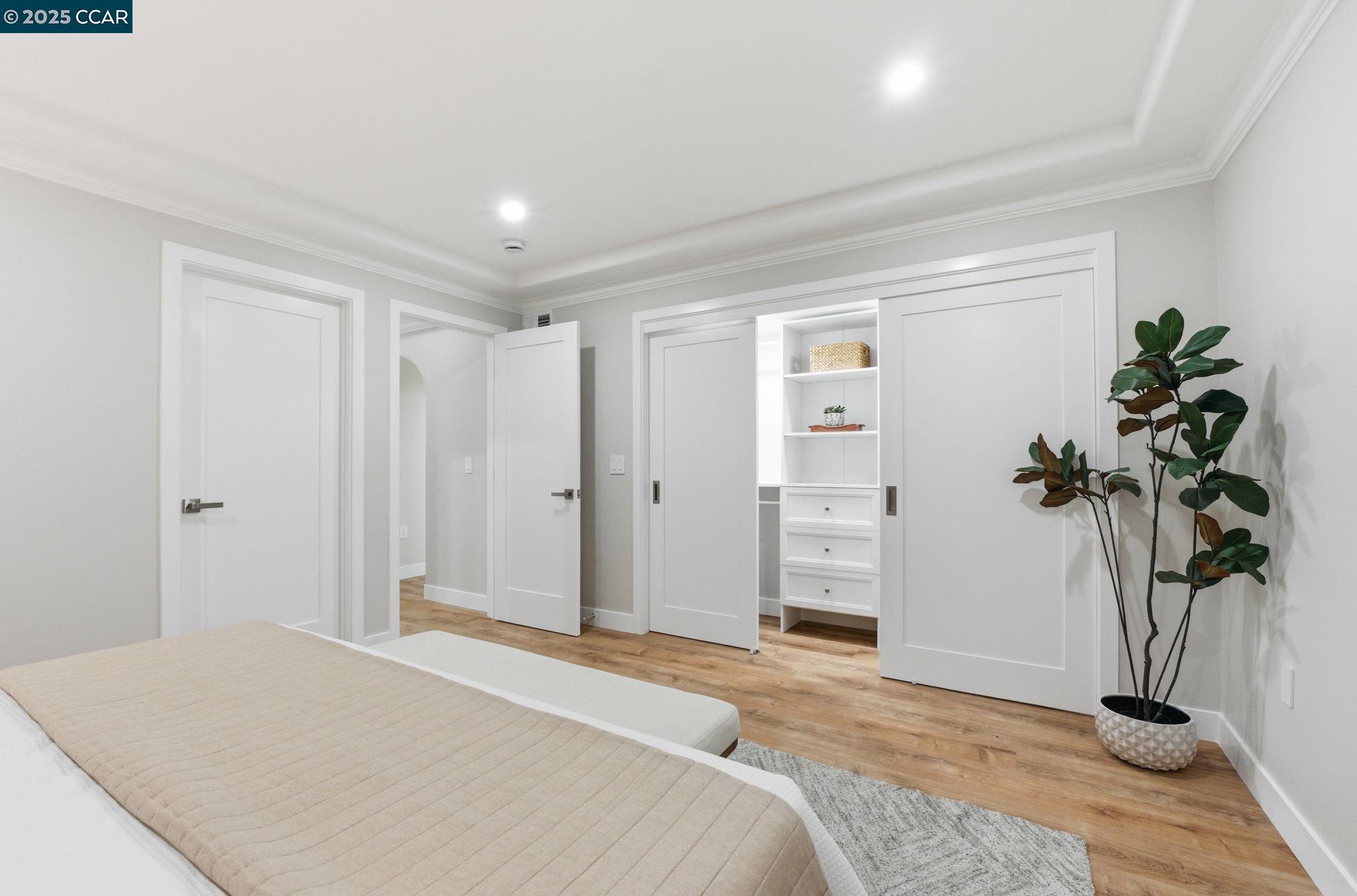 2132 Golden Rain Road, Unit 2 Walnut Creek, CA 94595 - Photo 16 of 38 a bedroom with a bed and a potted plant