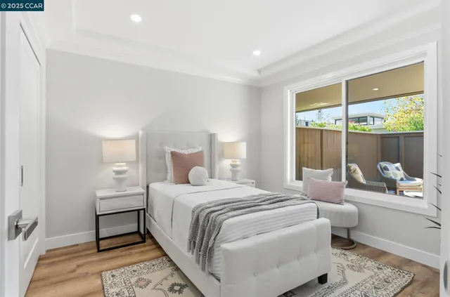 a bedroom with a bed and a large window