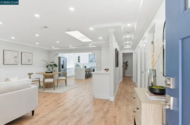 a living room with furniture a wooden floor and a large window
