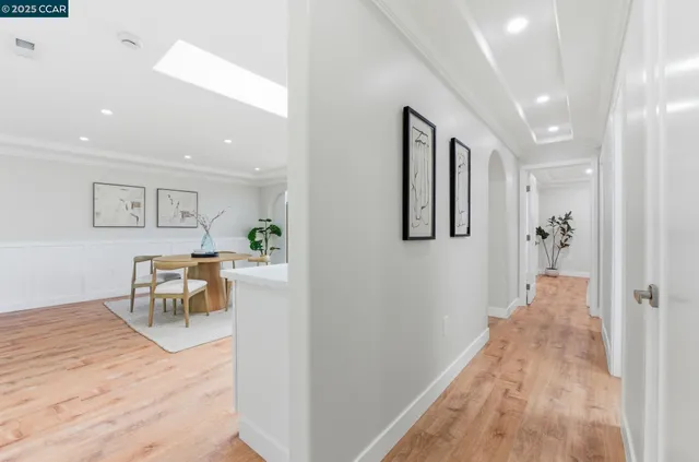 a view of a hallway with wooden floor and furniture